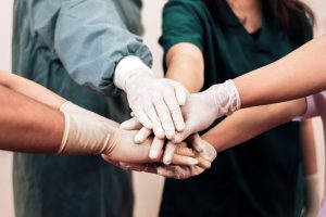 a group of healthcare professionals wearing gloves