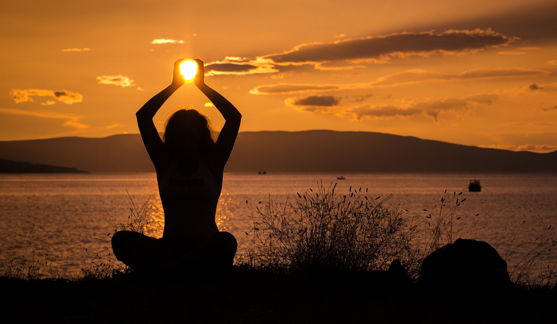 a person doing yoga at sunset